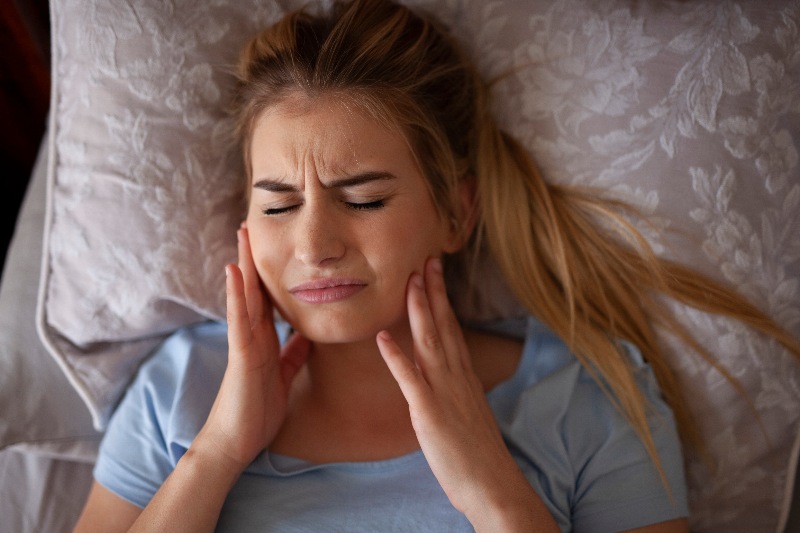 A Woman Experiencing Symptoms of Bruxism