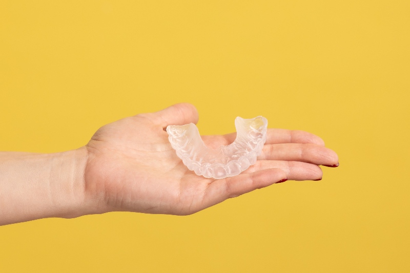 A Woman Holding a Palm Dental Aligner Retainer